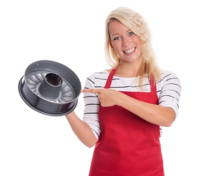 Housewife in apron points to a cake tin