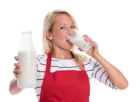 Woman in red apron drinks a glass of milk