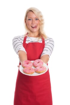 Blonde woman in apron holds plate with doughnuts