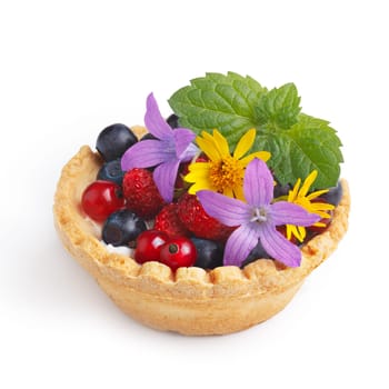 Dessert with wild berries decorated with mint leaves and wildflowers. Sweet tart with wild strawberry, blueberry and red currant. Large DOF