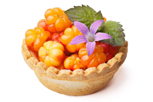 Cloudberry tart decorted with wild flower and mint leaves. Sweet baked dessert with fresh wild cloudberries. Large depth of field