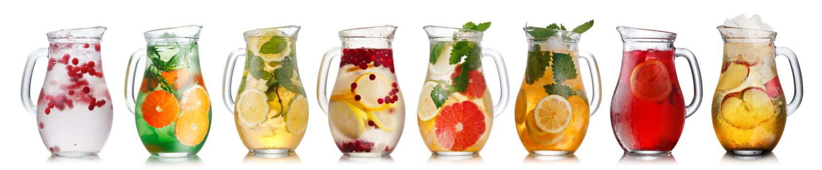 Collection of different drinks in glass pitchers. Jugs full of spritzers, schorle,lemonade,iced tea, detox waters.