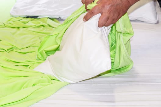 New duvet cover. Close up on green bedding.. Bed linen and pillows,are freshly covered.