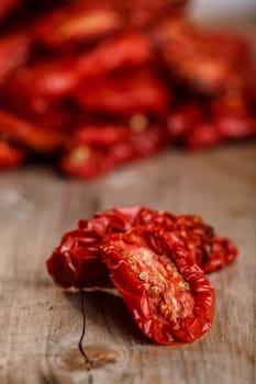 Sun dried tomatoes on  wooden table.Selective focus