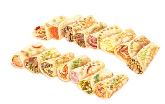 Large collection of elegant,neat, gourmet stuffed crepes decorated with herbs
