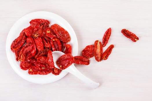 Sun dried tomatoes on bleached wooden table