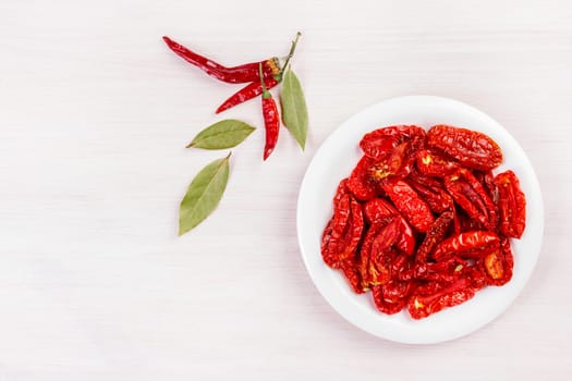 Sun dried tomatoes on bleached wooden table