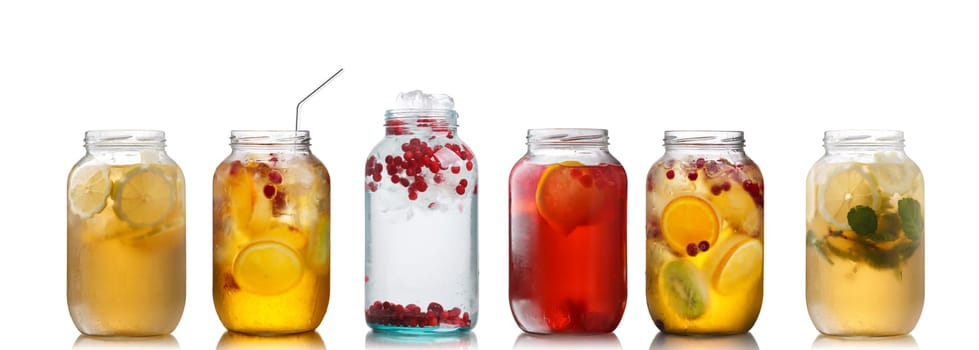 Collection of different drinks in glass jars. Glasses full of spritzers, schorle,lemonade,iced tea, detox waters. Healthy eating