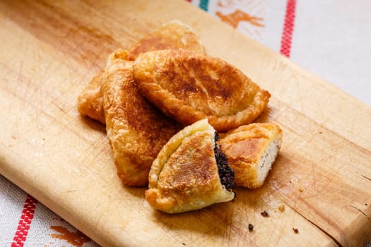 Colombian empanadas (snack sized savory patties) on wooden board. Latin cuisine