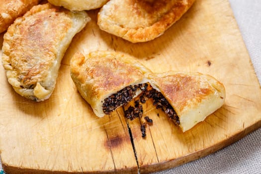 Colombian empanadas (snack sized savory patties) on wooden board. Latin cuisine