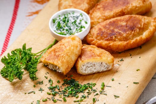 Colombian empanadas (snack sized savory patties) on wooden board. Latin cuisine