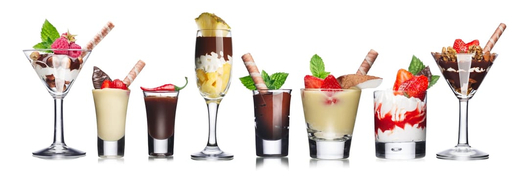 American parfait. Delicious layered desserts in elegant bar glasses decorated with fresh berries. Sweet food