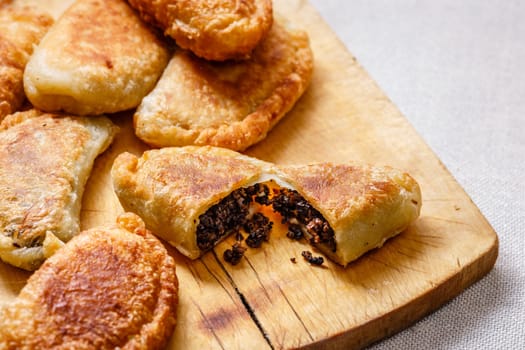 Colombian empanadas (snack sized savory patties) on wooden board. Latin cuisine