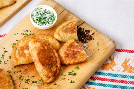 Colombian empanadas (snack sized savory patties) on wooden board. Latin cuisine