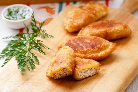 Colombian empanadas (snack sized savory patties) on wooden board. Latin cuisine