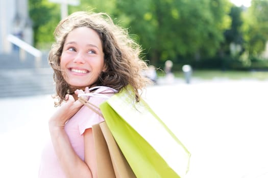 View of a Young attractive happy woman shopping in the city