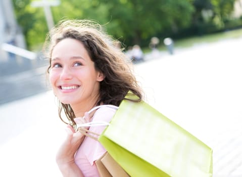 View of a Young attractive happy woman shopping in the city