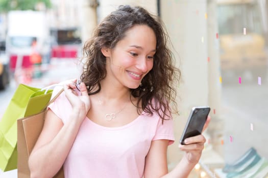 View of a Young attractive woman using mobile during shopping