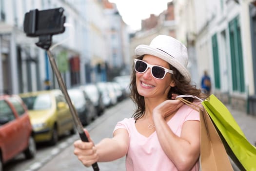 View of a Young attractive woman taking selfie while shopping