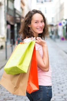 View of a Young attractive happy woman shopping in the city