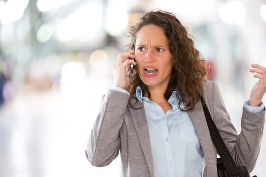 View of a Young attractive business woman using smartphone