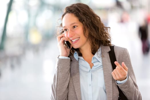 View of a Young attractive business woman using smartphone