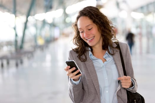 View of a Young attractive business woman using smartphone