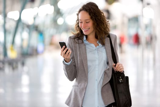 View of a Young attractive business woman using smartphone