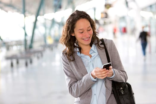 View of a Young attractive business woman using smartphone