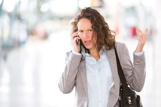 View of a Young attractive business woman using smartphone
