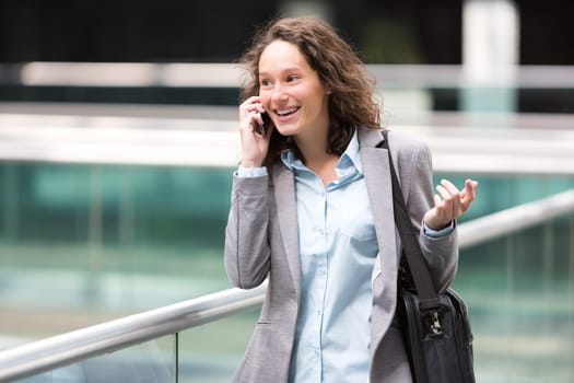 View of a Young attractive business woman using smartphone