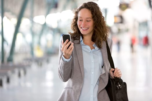 View of a Young attractive business woman using smartphone