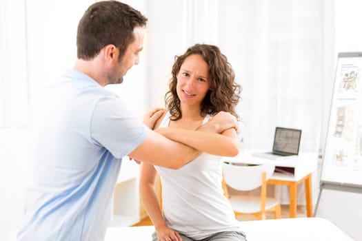View of an Young attractive woman being manipulated by physiotherapist