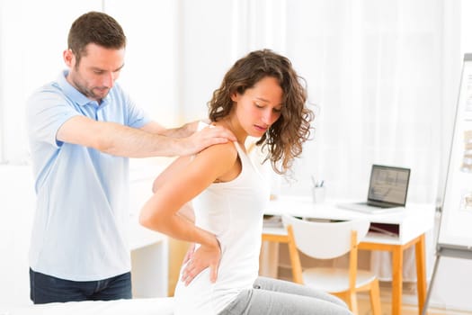 View of an Young attractive woman being manipulated by physiotherapist