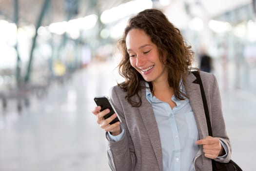 View of a Young attractive business woman using smartphone