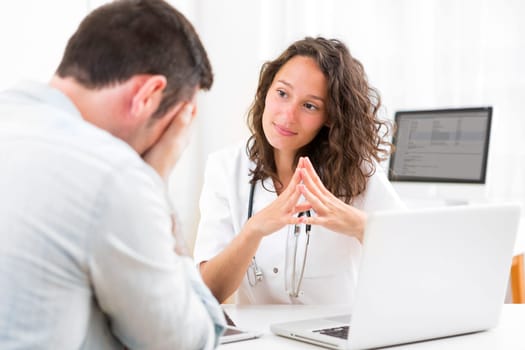 View of a Young attractive doctor listening his patient