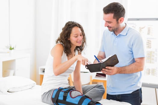 VIew of a Young attractive physiotherapist dating next appointment