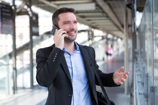 View of a Young attractive business man using smartphone