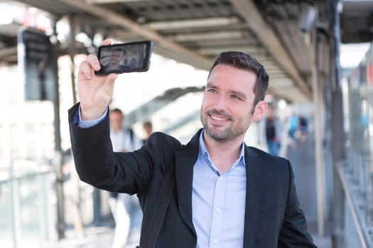 View of a Young attractive businessman taking some selfies