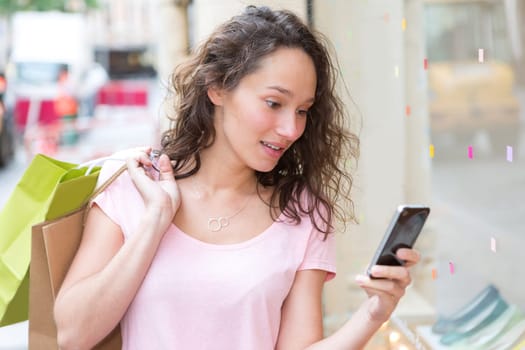 View of a Young attractive woman using mobile during shopping