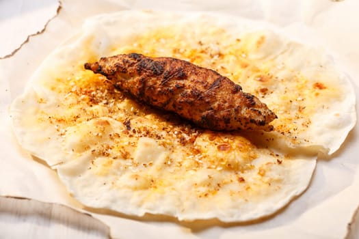 Shish kofte (kofta kebab) on naan spiced flatbread