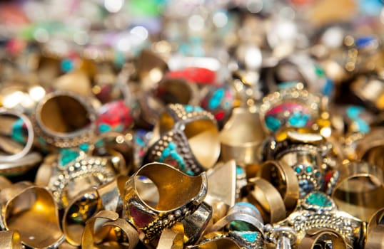 Loads of colorful rings of jewelry on street market stall
