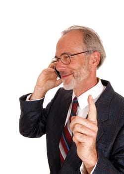 A middle age smiling business man talking on his cell phone, lifting up.his finger, telling wait, isolated for white background..