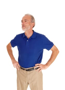 A serious looking middle age mal standing isolated for white background.with his hands on his hips..