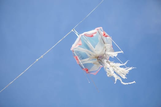 Hanging jellyfish made of recycled plastic over blue sky
