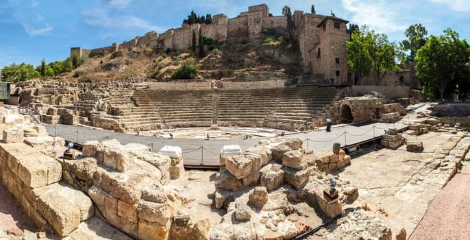Famous ancient Roman amphitheatre ruins at Malaga old town, Spain. Panoramic shot