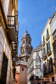 Malaga Cathedral tower from old town streets, Spain