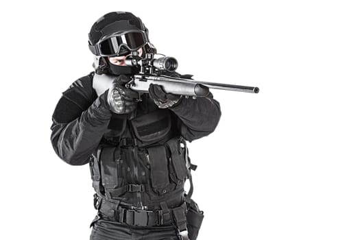 Spec ops police officer SWAT in black uniform and face mask studio shot