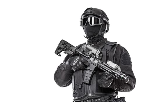 Spec ops police officer SWAT in black uniform and face mask studio shot