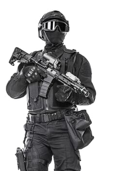 Spec ops police officer SWAT in black uniform and face mask studio shot
